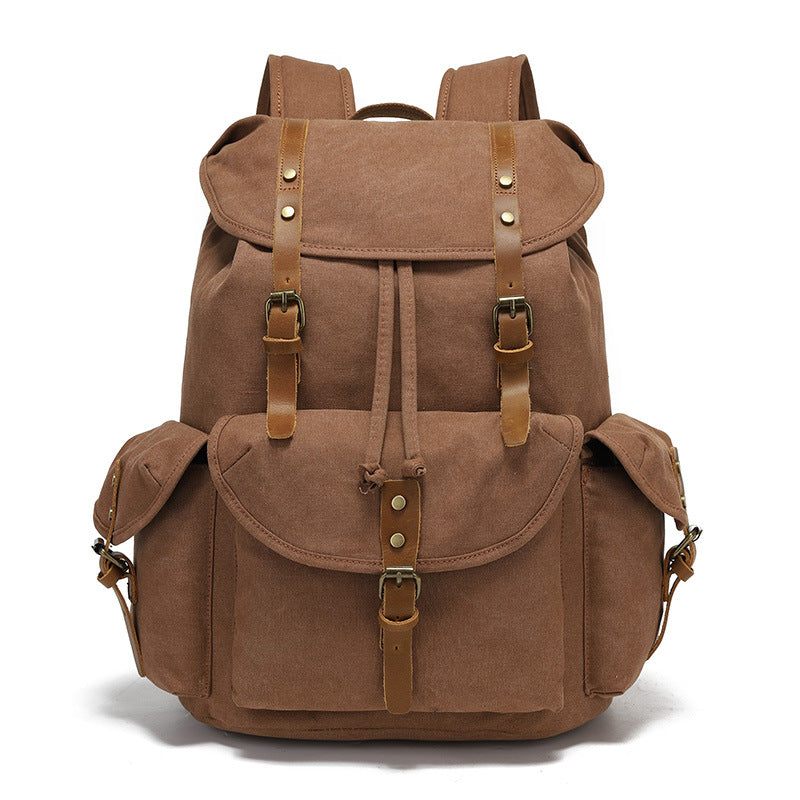 Front view of the Timbercarry vintage canvas multi-pocket backpack in brown, highlighting the classic vintage aesthetic with premium leather accents and brass buckles.