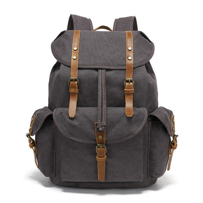 Front view of the Timbercarry vintage canvas multi-pocket backpack in dark grey, showcasing a versatile neutral color with functional leather strap closures.