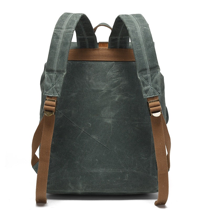 Vintage Waxed Canvas Rucksack Backpack - Back view of the forest green version, displaying the reinforced stitching, adjustable padded shoulder straps, and comfortable back panel design.
