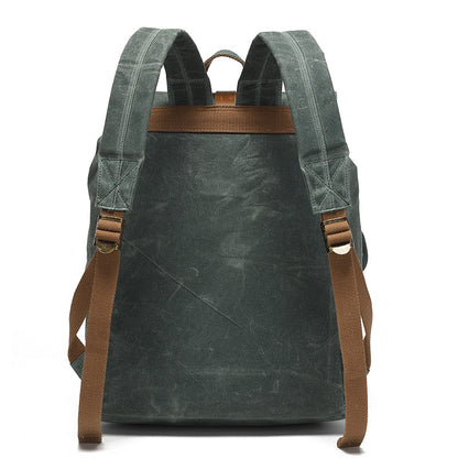 Vintage Waxed Canvas Rucksack Backpack - Back view of the forest green version, displaying the reinforced stitching, adjustable padded shoulder straps, and comfortable back panel design.