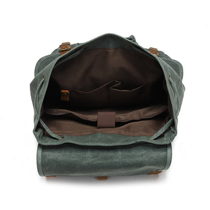 Vintage Waxed Canvas Rucksack Backpack - Interior view of the spacious main compartment, featuring brown lining, multiple organizer pockets, and a dedicated padded laptop sleeve.