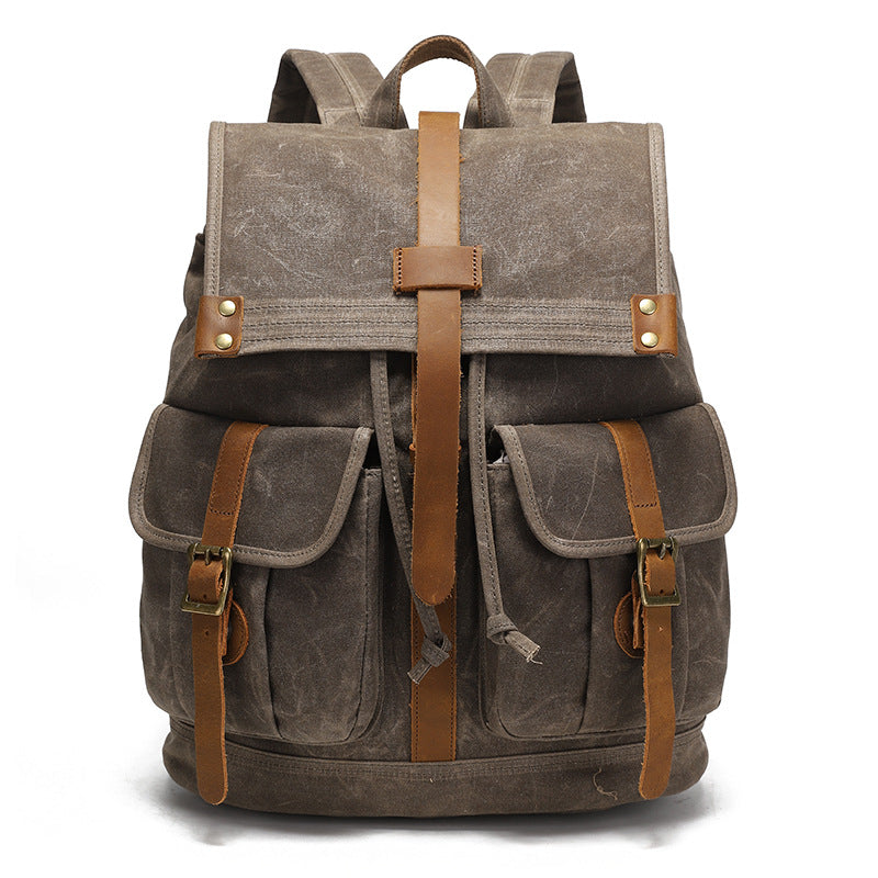 Vintage Waxed Canvas Rucksack Backpack - Front view of the earth brown version, showcasing the classic vintage design with rich leather accents and durable brass hardware.
