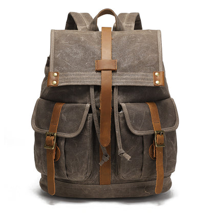 Vintage Waxed Canvas Rucksack Backpack - Front view of the earth brown version, showcasing the classic vintage design with rich leather accents and durable brass hardware.