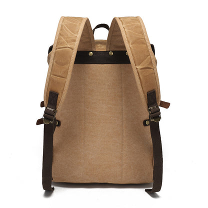 Back view of the vintage waxed canvas rucksack, featuring durable padded shoulder straps and reinforced stitching.