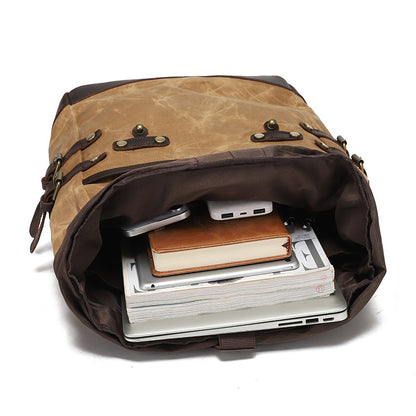 Interior view of the waxed canvas backpack with laptop and notebooks, highlighting spacious compartment and organization.