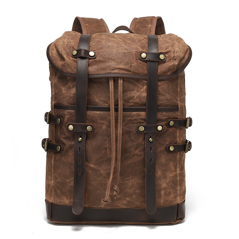 Dark brown vintage waxed canvas rucksack with classic leather buckle closures, perfect for outdoor travel.