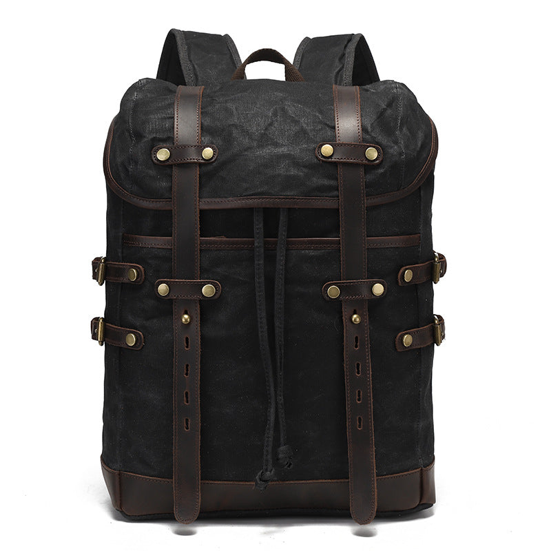 Black vintage waxed canvas backpack with leather buckle straps, demonstrating a sleek and durable design.