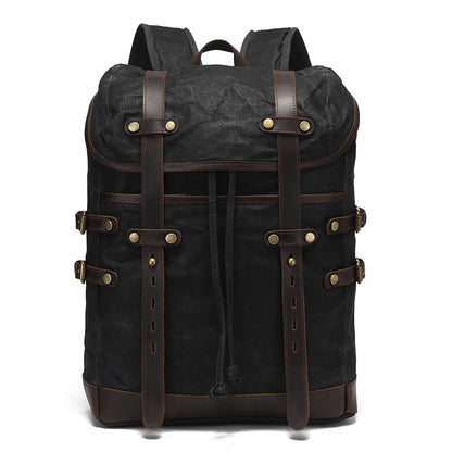 Black vintage waxed canvas backpack with leather buckle straps, demonstrating a sleek and durable design.