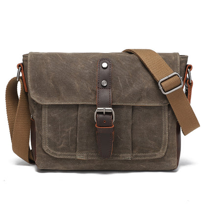 Vintage grey-brown waxed canvas messenger bag with brown leather details, front view.