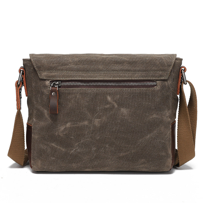 Back view of the grey-brown waxed canvas messenger bag with a durable zippered pocket.