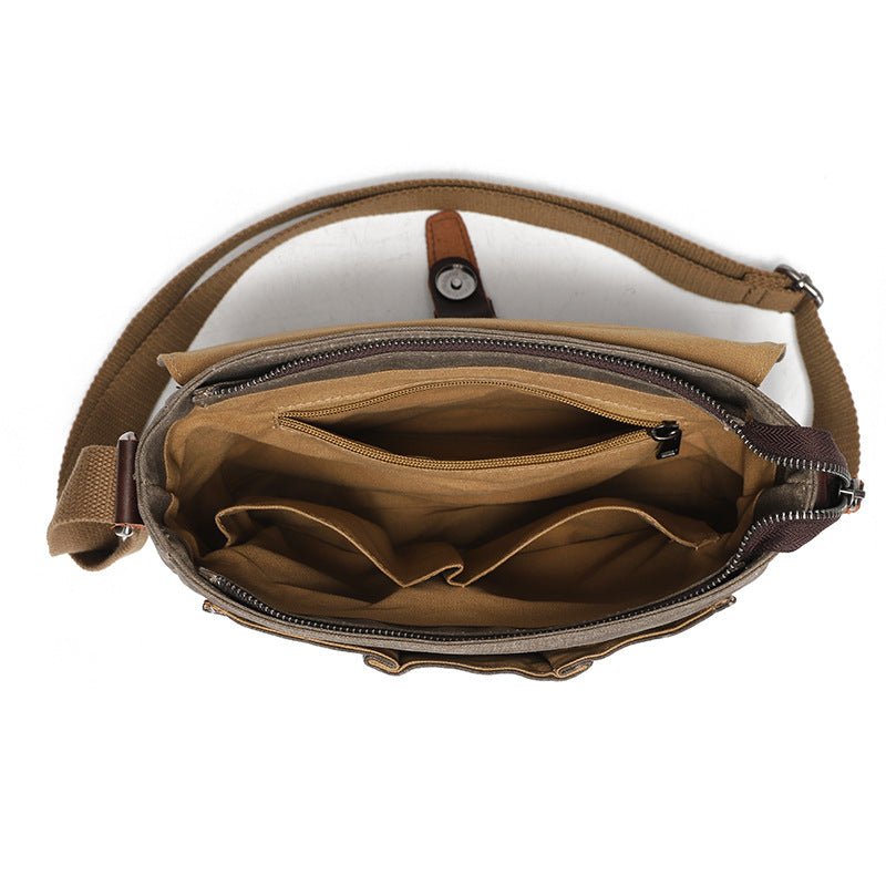 Interior of the waxed canvas messenger bag showing organizer pockets and brown cotton lining.