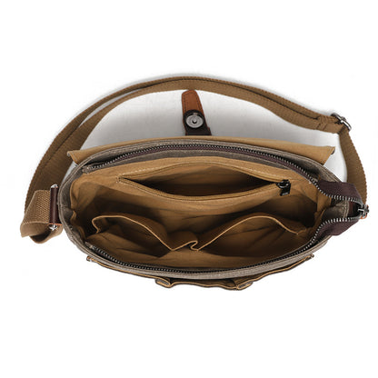 Interior of the waxed canvas messenger bag showing organizer pockets and brown cotton lining.