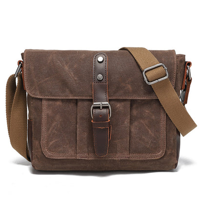 Vintage coffee brown waxed canvas messenger bag with leather buckle closure, front view.