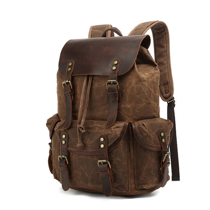 Vintage Waxed Canvas Multi-Pocket Rucksack in brown, featuring durable water-resistant canvas, brown leather flap, and multiple buckle-secured front pockets.