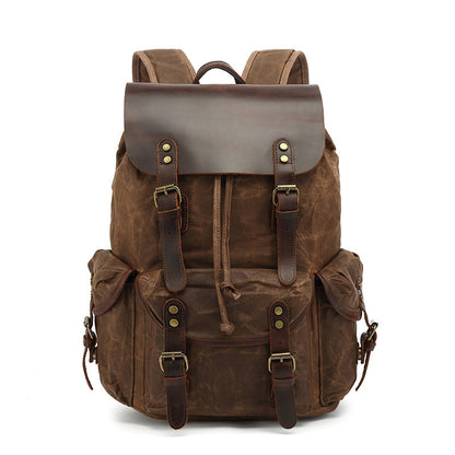Front view of the brown Vintage Waxed Canvas Multi-Pocket Rucksack, showcasing the drawstring closure, leather straps, and brass hardware details.