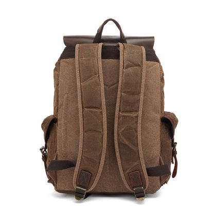 Back view of the brown Vintage Waxed Canvas Multi-Pocket Rucksack, showing the adjustable padded shoulder straps and reinforced stitching for comfort and durability.