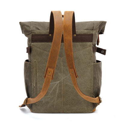 Back view of rugged waxed canvas backpack showing comfortable adjustable leather straps