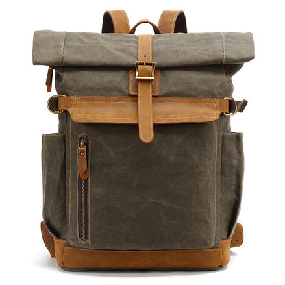 Front view of army green rolltop backpack made of waxed canvas and leather