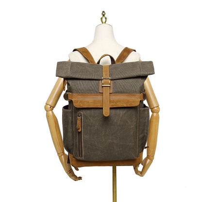 Waxed canvas rolltop backpack displayed on a mannequin for size reference